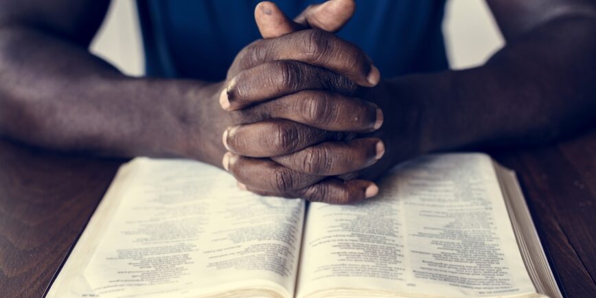 praying over open bible