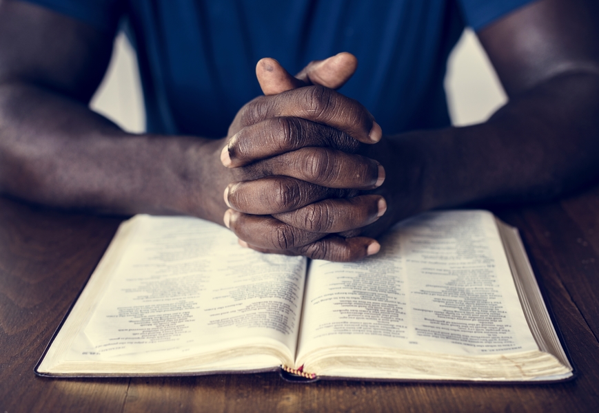 praying over open bible