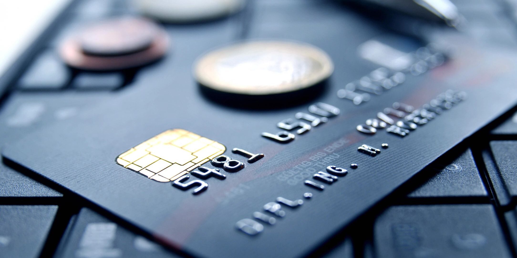 pile of credit cards with change on top